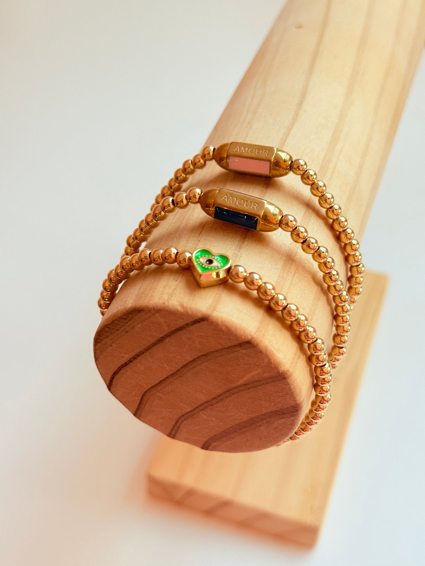 Gold beaded bracelet with charm bead