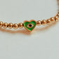 Gold beaded bracelet with charm bead