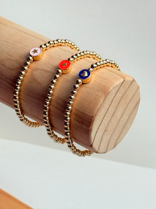 Gold beaded bracelet with charm bead