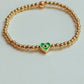 Gold beaded bracelet with charm bead