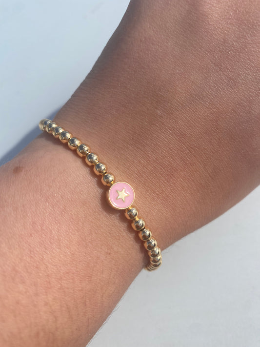 Gold beaded bracelet with charm bead